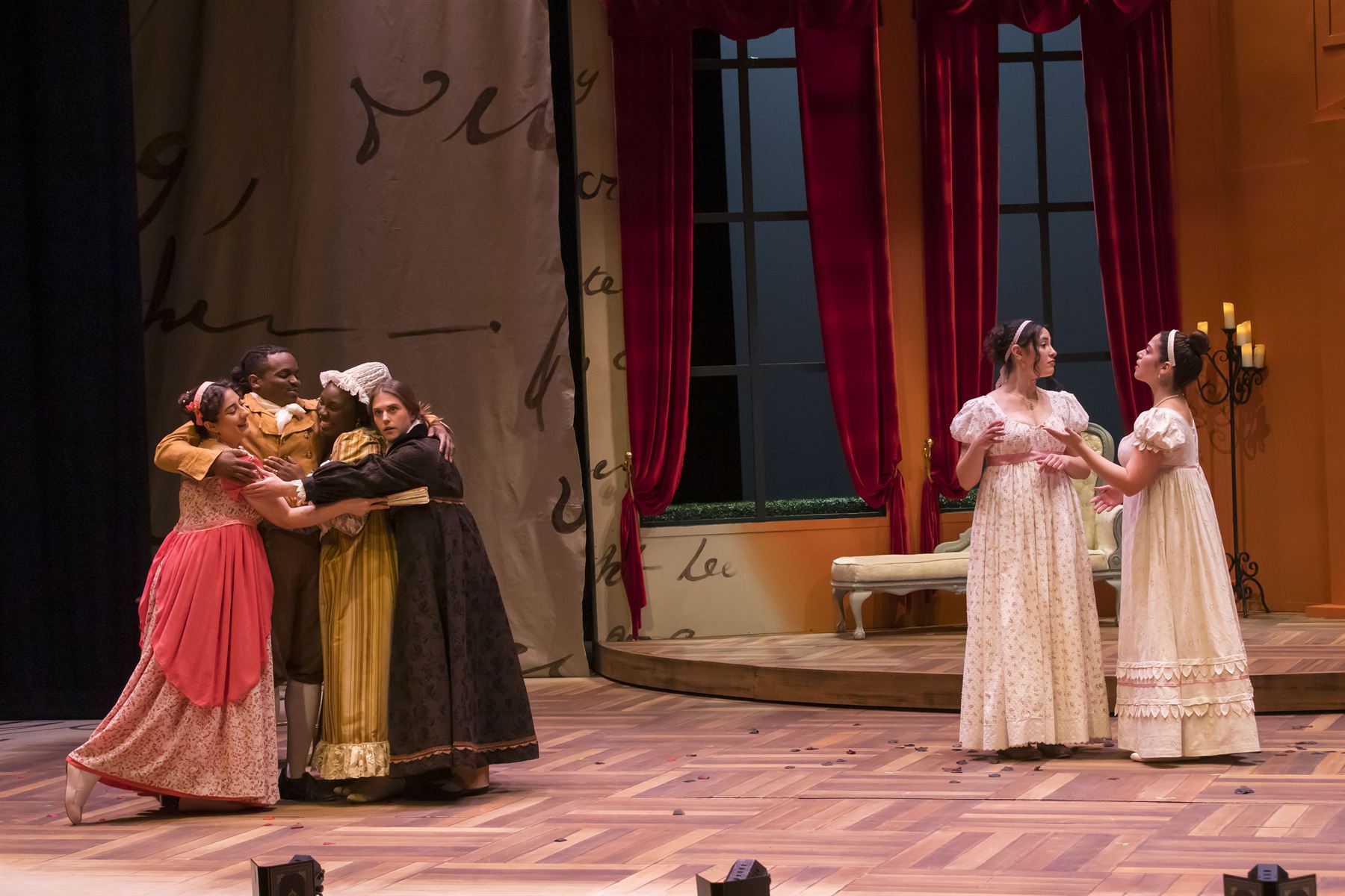 The company gathers in celebration before the curtain